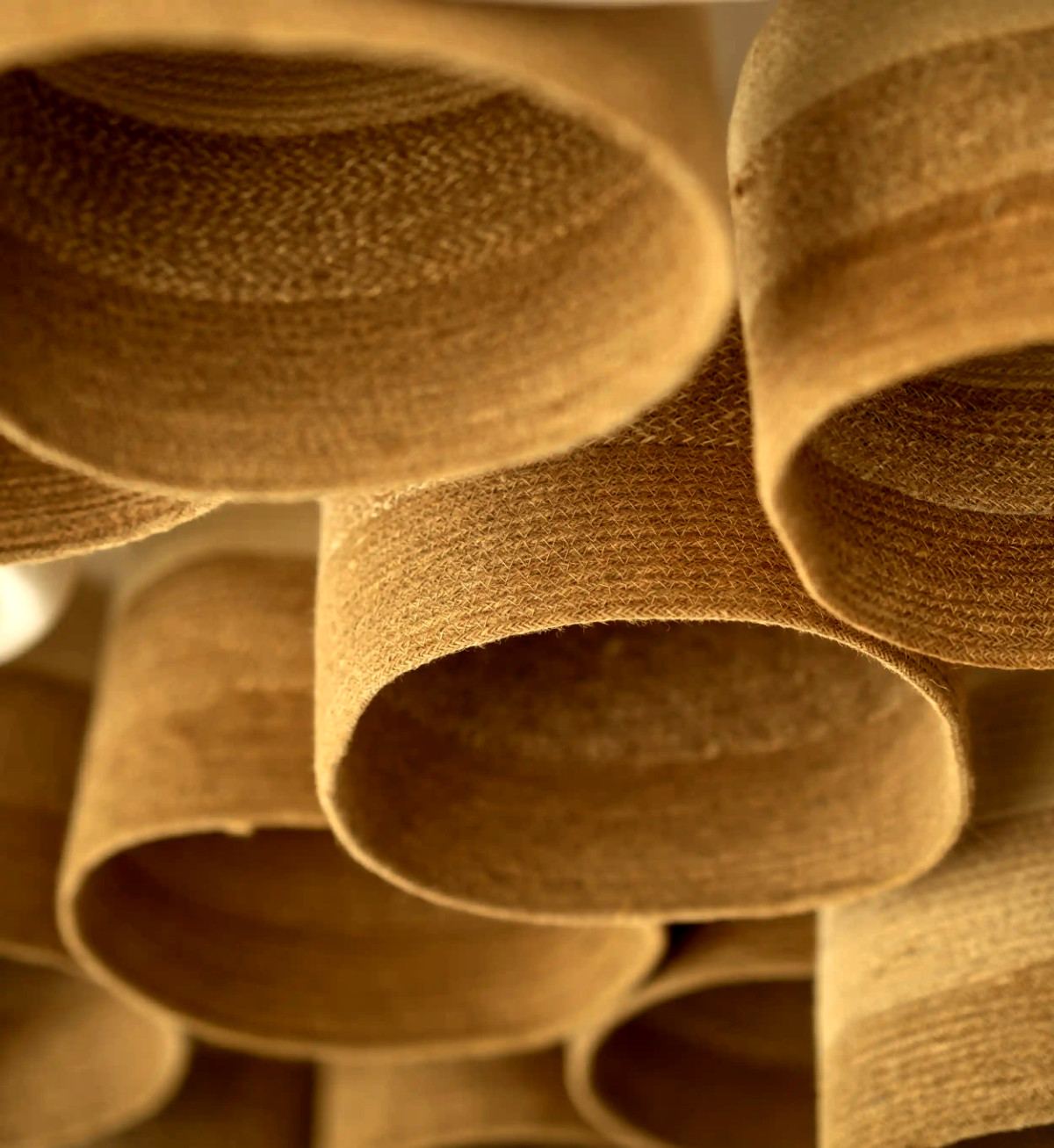 Close-up of woven jute pendant lampshades in the lounge at Le Pont de l’Amitié
