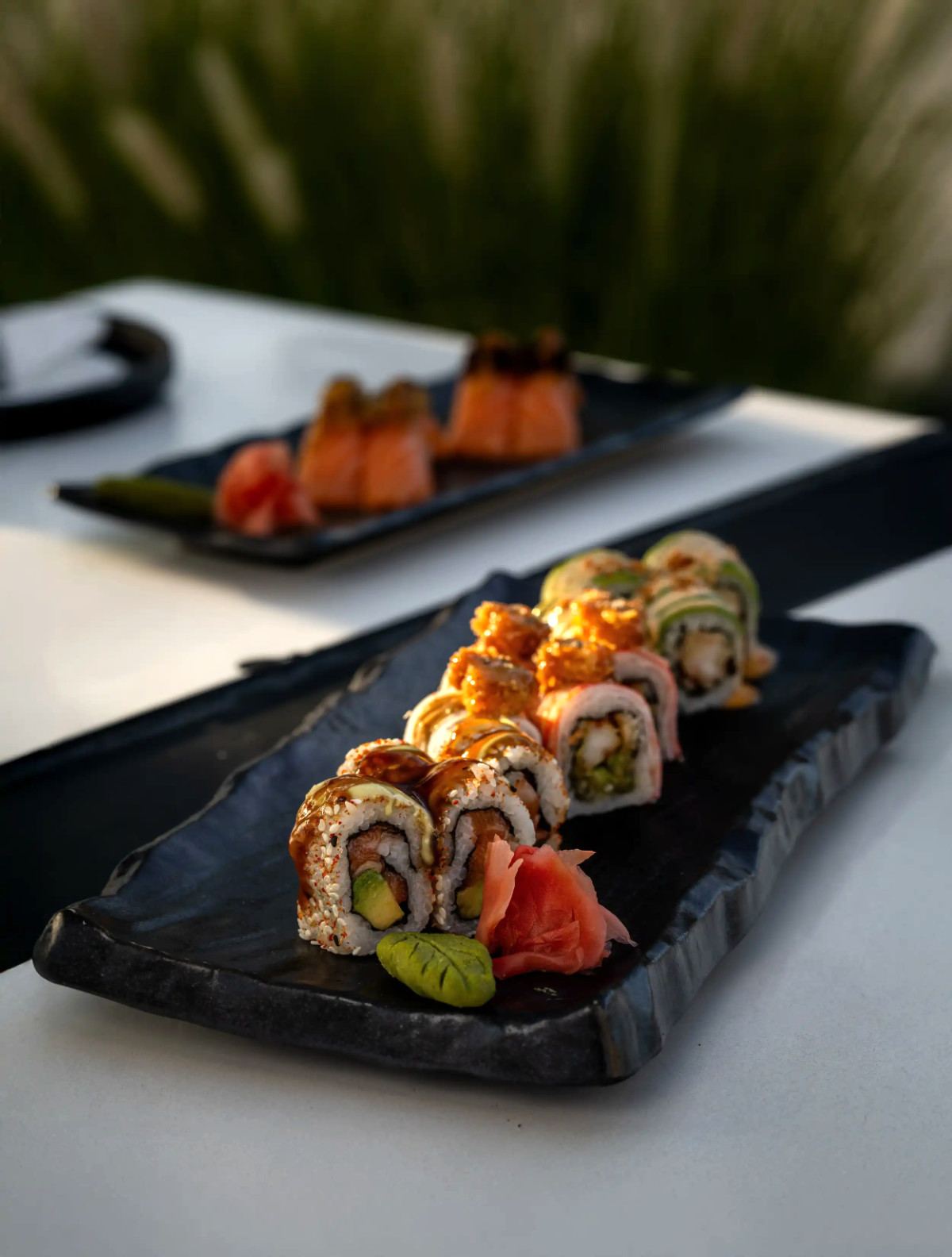 Sushi rolls with pickled ginger and wasabi served on slate platters at Shades Beach Club