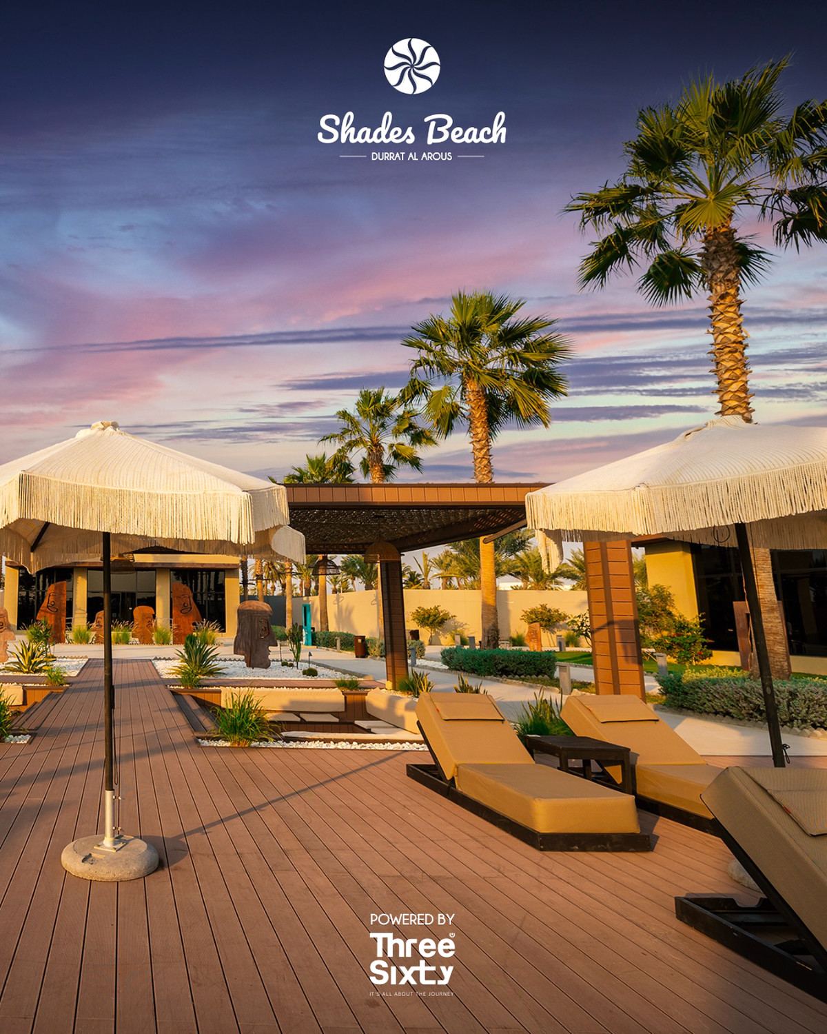 Fringed parasols and loungers on a sunset deck at Shades Beach Club, with Shades and Three Sixty logos